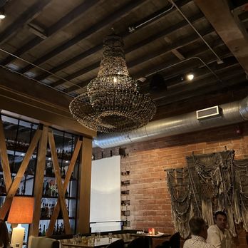 Bridgette Bar - a chandelier hanging from the ceiling - Bars Near Me - Calgary, Alberta Bridgette Bar - a chandelier hanging from the ceiling - Bars Near Me - Calgary, Alberta