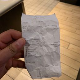 a hand holding a receipt a hand holding a receipt