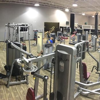 ASK Fitness - View of our main gym. Separate stretching area behind black window wall, with a cardio deck under the lime green. - Trainers Near Me - Minot, North Dakota ASK Fitness - View of our main gym. Separate stretching area behind black window wall, with a cardio deck under the lime green. - Trainers Near Me - Minot, North Dakota