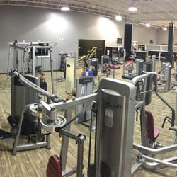 ASK Fitness - View of our main gym. Separate stretching area behind black window wall, with a cardio deck under the lime green.