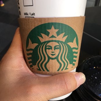 Starbucks - a hand holding a starbucks cup - Coffee & Tea Near Me - Richmond, British Columbia Starbucks - a hand holding a starbucks cup - Coffee & Tea Near Me - Richmond, British Columbia