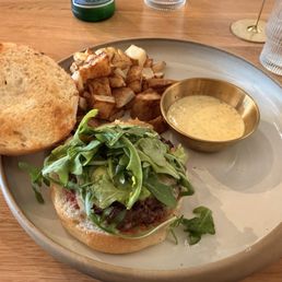 Grass-fed burger with arugula, cheese, honey mustard and jam with roasted potatoes Grass-fed burger with arugula, cheese, honey mustard and jam with roasted potatoes