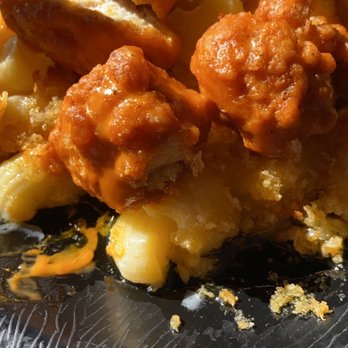 Buffalo Wild Wings - a closeup of buffalo wings and cheesy macaroni and cheese - Sports Bars Near Me - Greenville, North Carolina