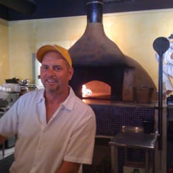 Chris infrint of the wood burning oven.
