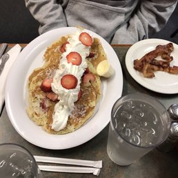 a plate of pancakes with strawberries and bacon a plate of pancakes with strawberries and bacon