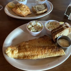 Manor On Main - Seafood stuffed salmon with potato salad top plate. Pan fried walleye and potato salad bottom plate.