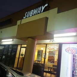 a car parked in front of a subway restaurant