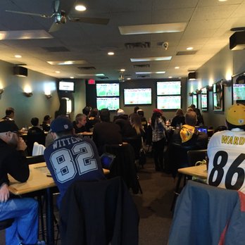 E'z Place - a group of people sitting at tables watching televisions - Pizza Near Me - Omaha, Nebraska