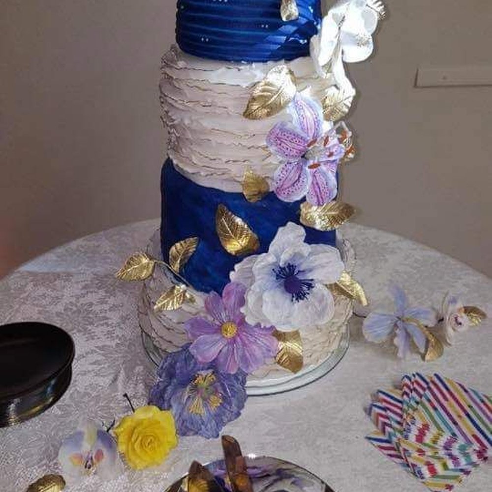 Set It Off- Eats & Treats - Wedding Cake made with several different cake flavors in each layer and hand-crafted gum paste flowers for decorations. - Desserts Near Me Set It Off- Eats & Treats - Wedding Cake made with several different cake flavors in each layer and hand-crafted gum paste flowers for decorations. - Desserts Near Me