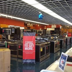 Bray & Scarff - Home appliance showroom with various appliances on display and a red and black banner