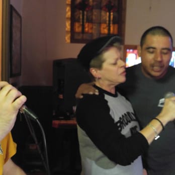 Hummel's Pub - a man and woman singing into a microphone - Pubs Near Me - Saint Louis, Missouri