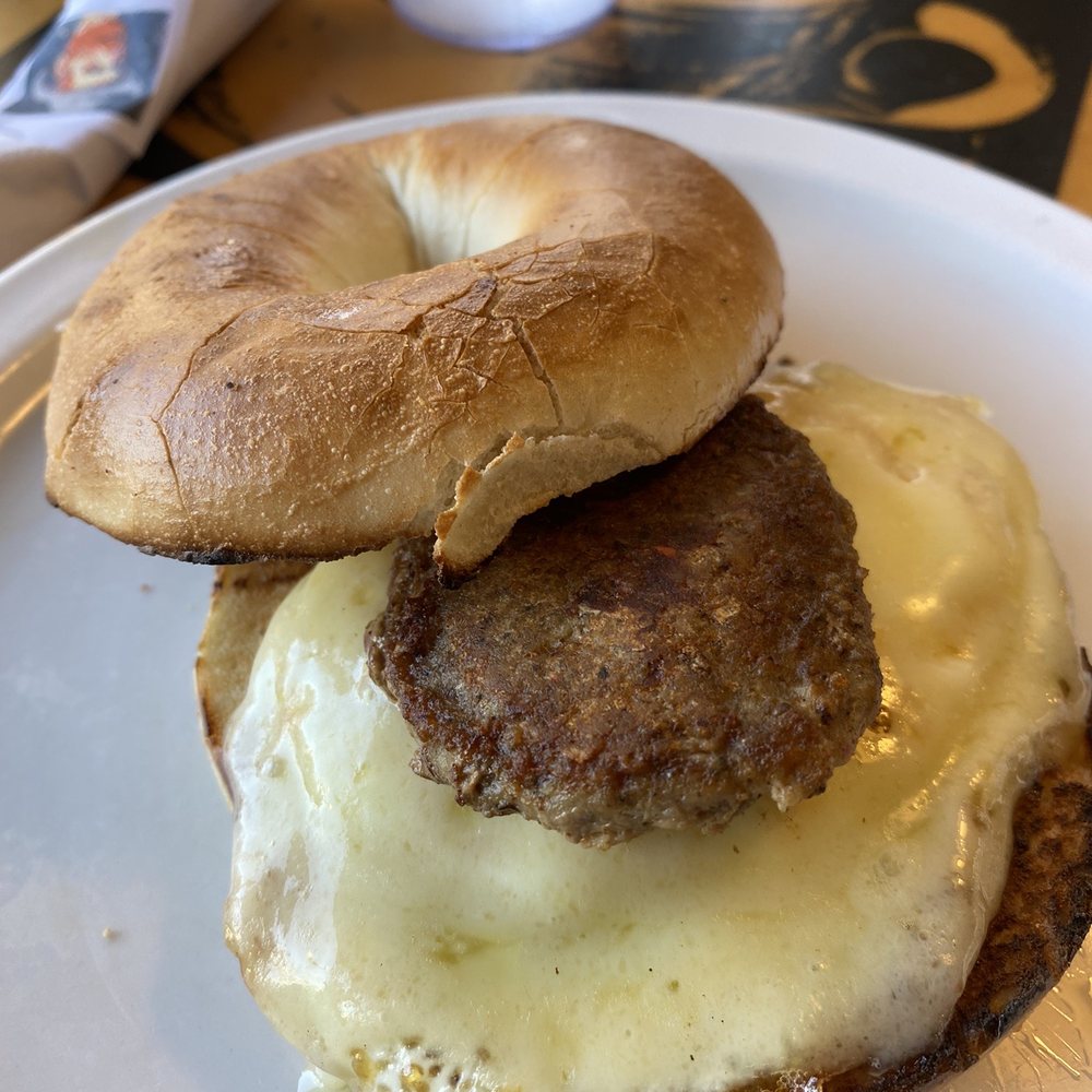 Wolfgang's Restaurant - Mo's bagel sandwich with a tiny turkey sausage - Breakfast & Brunch Near Me - Grand Rapids, Michigan Wolfgang's Restaurant - Mo's bagel sandwich with a tiny turkey sausage - Breakfast & Brunch Near Me - Grand Rapids, Michigan