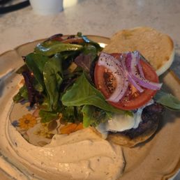 Cheeseburger with bacon on english muffin and side salad Cheeseburger with bacon on english muffin and side salad