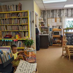 Hilltop Preschool - My 4-yr old son hanging out at the classroom library full of preschool books after school