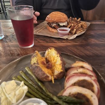 Bacon, Bourbon & Beer - My boyfriend got the farmhouse burger, and I got the bacon wrapped stuffed chicken with loaded baked potato and asparagus - Cocktail Bars Near Me - Morgantown, West Virginia