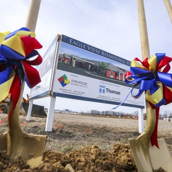 Thomas Construction Group - shovels and ribbon tied to a sign - General Contractors Near Me - Wilmington, North Carolina Thomas Construction Group - shovels and ribbon tied to a sign - General Contractors Near Me - Wilmington, North Carolina