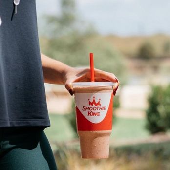 Smoothie King - a person holding a cup of coffee - Juice Bars & Smoothies Near Me - Bettendorf, Iowa