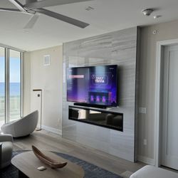 Klass Act Solutions - TV and speaker bar mount on a designer inspired porcelain wall in an oceanfront condo.