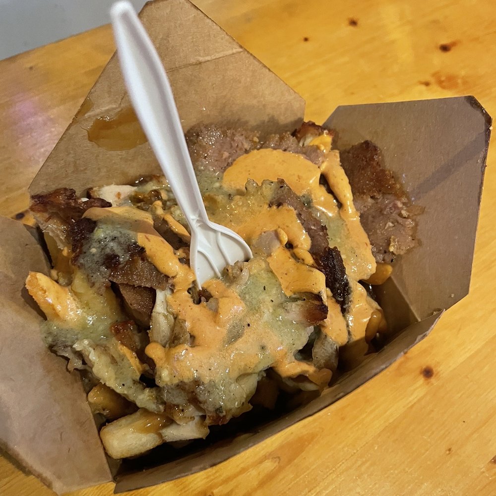 a fork sticking out of a box of fries a fork sticking out of a box of fries