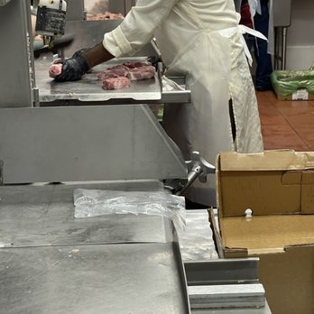 Al Barakah - a man preparing food in a kitchen - Delis Near Me - Decatur, Georgia
