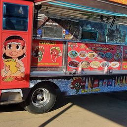 a food truck parked in a parking lot a food truck parked in a parking lot