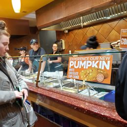 a woman ordering food at a restaurant a woman ordering food at a restaurant