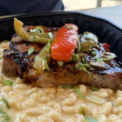 Wicked Willy's Sports & Tiki Bar - They had a special bone in pork chop with peppers and onions over homemade Mac n cheese. Was great portion size for only $18!