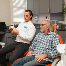 Red Bank Smiles - Dr. Benjamin Klayman discussing bite alignment with a patient.