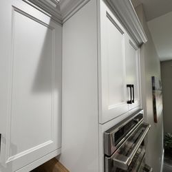 Rainier Woodworking Company - cracking and peeling paint is between door/hinge all the way down into the oven area.