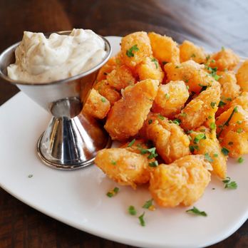 Merchant - a plate of fried shrimp with a side of dip - Cocktail Bars Near Me - Madison, Wisconsin Merchant - a plate of fried shrimp with a side of dip - Cocktail Bars Near Me - Madison, Wisconsin