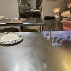 Nino's Pizzeria - Pizza dough in the back waiting to be cut
