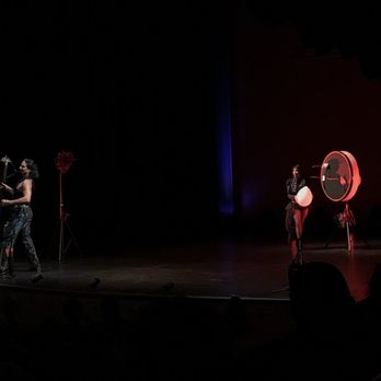 Historic Asolo Theater - Attractive couple skillfully shooting bow and arrow - Cinema Near Me - Sarasota, Florida