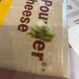 a box of cheese and a piece of broccoli a box of cheese and a piece of broccoli
