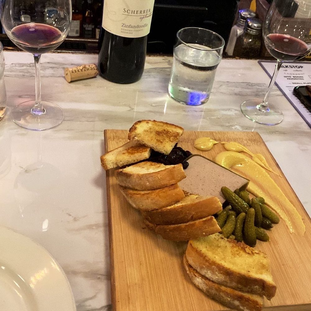 Pâté served with mustard, pickles, and cranberry preserves.