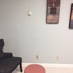 Boca Babes OBGYN - Homey chairs and walk art in exam room