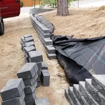 Pryde Tree & Landscape Services - a red truck parked next to a pile of bricks - Landscaping Near Me - Carson City, Nevada Pryde Tree & Landscape Services - a red truck parked next to a pile of bricks - Landscaping Near Me - Carson City, Nevada