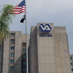 US Department Of Veterans Affairs - Flagpole with POW / MIA flag flying high.