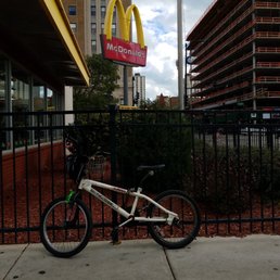 a bicycle leaning against a fence