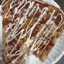 a slice of pizza on a paper plate a slice of pizza on a paper plate