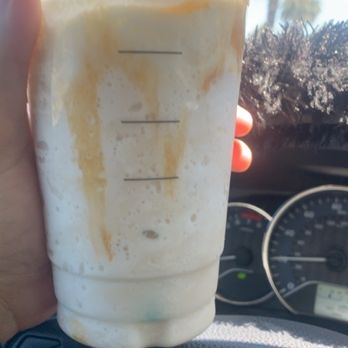 Starbucks - a hand holding a cup of coffee - Coffee & Tea Near Me - Patterson, California