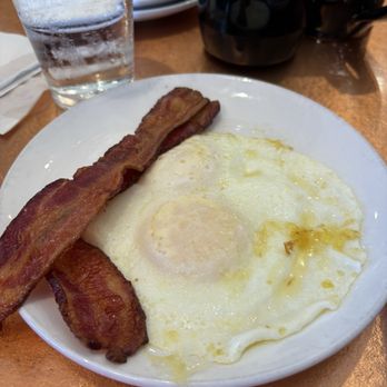 Another Broken Egg Cafe - Eggs and bacon came on the side of the bourbon pancakes - Breakfast & Brunch Near Me - Baton Rouge, Louisiana Another Broken Egg Cafe - Eggs and bacon came on the side of the bourbon pancakes - Breakfast & Brunch Near Me - Baton Rouge, Louisiana