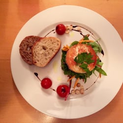 Estrella restaurant - Grilled Goat Cheese on mesclun salad with cherry tomatoes, hazelnuts as acacia honey, baked toast