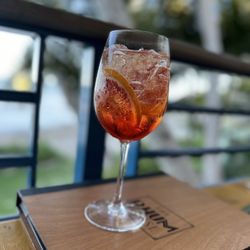 The Rhum House - Aperol spritz with blood orange slices.