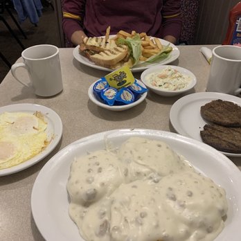 Cackleberries - Biscuits and gravy, side of eggs over easy and sausage patties. That sandwich is a panini. - Breakfast & Brunch Near Me - Terre Haute, Indiana