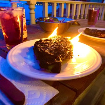 Paci Restaurant - a slice of cake on a plate with a lit candle - Italian Near Me - Southport, Connecticut Paci Restaurant - a slice of cake on a plate with a lit candle - Italian Near Me - Southport, Connecticut