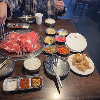 Meat Love Korean BBQ - Prime brisket on the grill and all the sides. Also fried dumplings. - Korean Near Me - Los Angeles, California