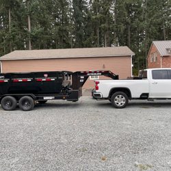 Hoss Dumpster Rental - This is our clean and presentable work truck pulling out 14  yard dumpster.