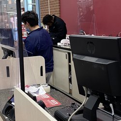 Burlington - Staff sitting on counter, totally distracting the only cashier.