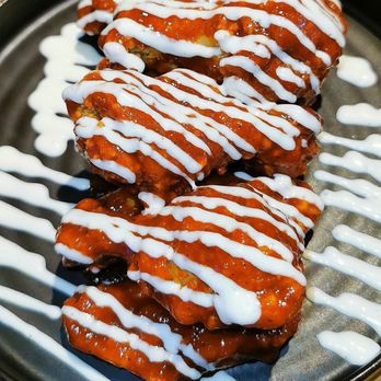 Wingzilla - a plate of wings covered in sauce - Chicken Wings Near Me - Toronto, Ontario