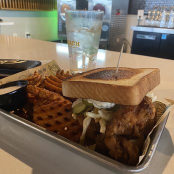 Gold Feather - Nashville hot chicken sandwich with sweet potato fries and the marshmallow sauce. - Beer Bar Near Me - San Antonio, Texas Gold Feather - Nashville hot chicken sandwich with sweet potato fries and the marshmallow sauce. - Beer Bar Near Me - San Antonio, Texas